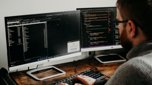 man working on computer coding